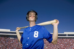 Baseball player, in number Ã?Â¢Ã¢Â?Â¬Ã?Â?8Ã?Â¢Ã¢Â?Â¬Ã¢Â?Â¢ blue uniform, helmet and face paint, standing on pitch with bat behind head, low angle view, portrait