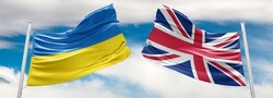 Ukraine and United Kingdom two flags on flagpoles and blue sky. military help to ukraine