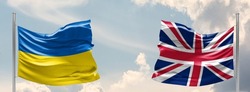 Ukraine and United Kingdom two flags on flagpoles and blue sky. military help to ukraine