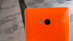 Nokia Lumia 930. Old Nokia. Orange colour smartphone back side camera and flash close Up, micro
