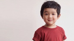 Cute Asian child little Thai boy 2 year old smile make a happy face concept.                     