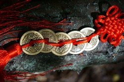 A bunch of Chinese coins that attract good luck and wealth. Hieroglyphs mean attracting good luck and financial well-being.