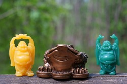 Metal toad figurine and Buddha figurines. Talismans and amulets. The feng shui symbol. Good luck and favorable events.