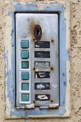 Old ruined intercom on the wall of a building