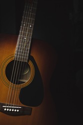 Acoustic guitar on a dark background