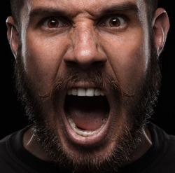 Close-up portrait of screaming and angry man