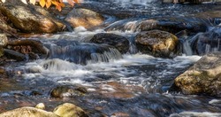 water cascading  over rocks in trap falls brook in willard brook state forest in ashby massachusetts