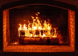 Glowing fire in a huge stone fireplace