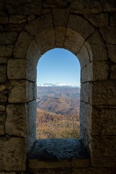 View from the window of the Akhun tower in Sochi on the black forest and mountains in the snow