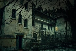 Old abandoned mansion in mystic spooky forest. The ancient haunted house of the crime scene with dark horror atmosphere and creepy details