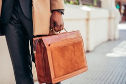 Business man holding a briefcase.