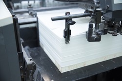Stack of paper in a printing press.