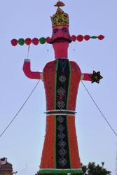 vertical view of ravan with ten heads standing in the field for celebration of dussehra festival in india