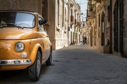 An old Fiat 500 in the old city centre of Syracuse, Sicily, Italy.