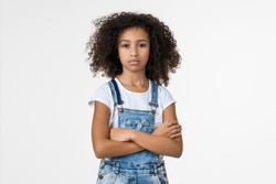Portrait of angry preteen african american girl on white background