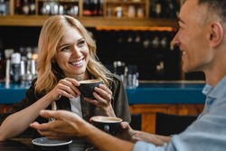 Bonding relationship. Interested excited falling in love mature woman listening to her husband man boyfriend while drinking coffee in restaurant cafe on a date