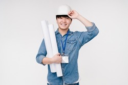 Active happy smiling asian korean young male man architect construction worker in white hardhat holding architectural plans on building isolated in white background