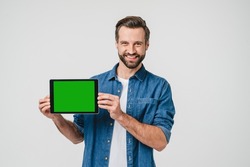 Green mockup screen for ad copyspace freespace. Caucasian young man holding digital tablet, showing screen with mobile application, online social media isolated in white