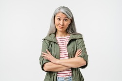 Offended caucasian middle-aged mature woman in casual clothes blowing her lips with arms crossed isolated in white background. Angry wife