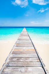 Jetty on a beautiful island in the caribbean with white sand and blue sea