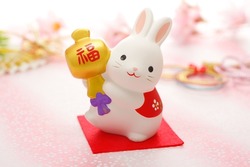 New Year's greeting card for the year of the rabbit. Horizontal version. The rabbit is holding a small mallet on which is written 