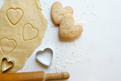 Making homemade heart shaped cookies from ginger raw dough - festive homemade cookies pastry for Valentine day