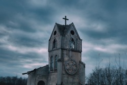 Ancient abandoned Church against a dark sky. Cityscape on Halloween, copy space