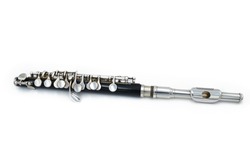 Black piccola flute on a white isolated background