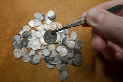 A treasure trove of silver coins from the reign of Ivan 4 the Terrible. Medieval money of Russia in the hands of a collector. Study and attribution of coins. Numismatics, collecting.