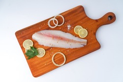 fresh fillet dory fish on wooden tray
