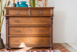 old antique old mahogany chest of drawers in a room with additional decor