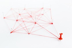 A large mesh of pins connected with a cord. Communication, network concept. Red