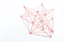 A large mesh of pins connected with a cord. Communication, network concept. Red