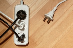 Extention cord, Extension cable with three plug socket  on wooden  background. Copy space