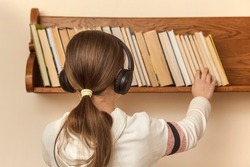 Choosing book. Teen chooses  book, audiobook. Teenager's leisure