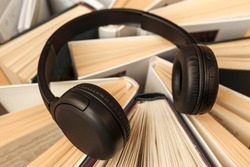 Audio book concept. Headphones on books. Earphones for online learning, listening audio.