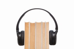 Headphones on books isolated on white background. Audio books isolated. Listening audio. Space for text