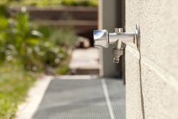 Faucet Outside on house wall, outdoor garden Water Tap against brick wall. 