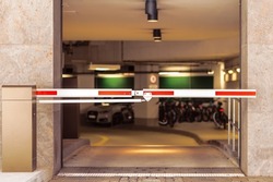 Entrance Gate to underground garage parking. Automobile parking inside. Automatic barrier in underground car parking. 