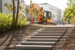 Stair Construction in Park. Installing Stone Stairway, Staircase  by Excavator in City Park. Laying Concrete Stairs,  Footpath, Sidewalk concept.
