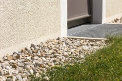 Drainage System Floor around  Perimeter of House with Gravel floor, Stainless Drain Grate, Drain Stones. 