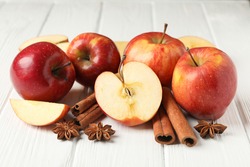 Apple and cinnamon on wooden background, close up
