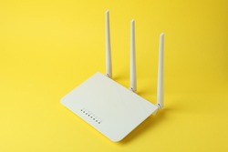 Wi-Fi router with external antennas on yellow background