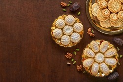 Assorted semolina maamoul or mamoul cookies with dates , walnuts and pistachio nuts. Traditional arabic Eid al Adha, Eid al Fitr sweets . Top view, flat lay