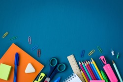 School supplies on blue background. Top view. Copy space.