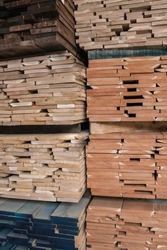 Stacks of lumber on a rack for sale to consumers at a retail hardwood lumber business