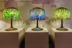 Three Tiffany table lamps with blue and green shades
