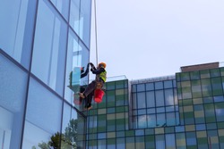 Window cleaner on high-rise buildings. Industrial climber.