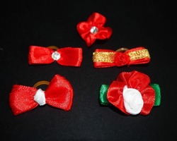 close five small red jars on a silicone rubber band for dogs lie on a black background.  side view.  dog accessories .  bows