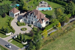 Aerial view over a large upscale luxury house on a sunny summer day. Canada.
